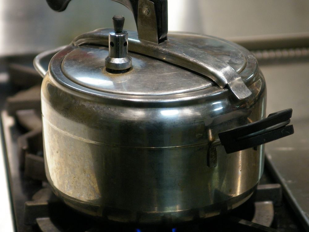 Stainless steel pressure cooker on a gas stove — Vinod and KenCook cookers available in Chikhli, Navsari